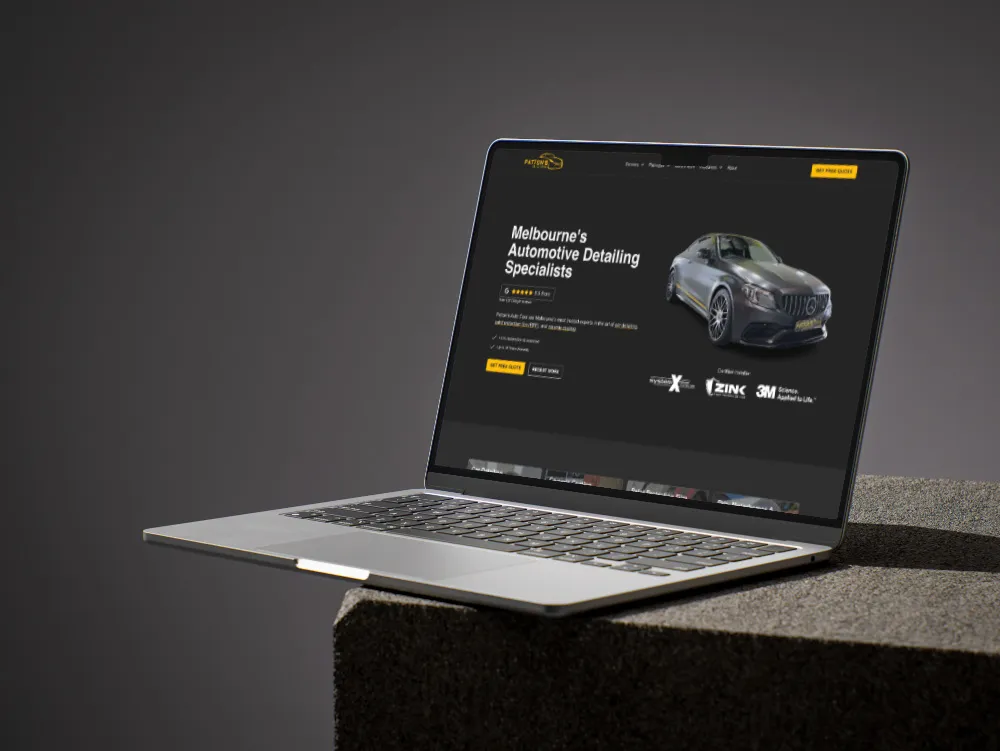 Macbook laptop with automotive website built by Wolfstack displayed on the screen