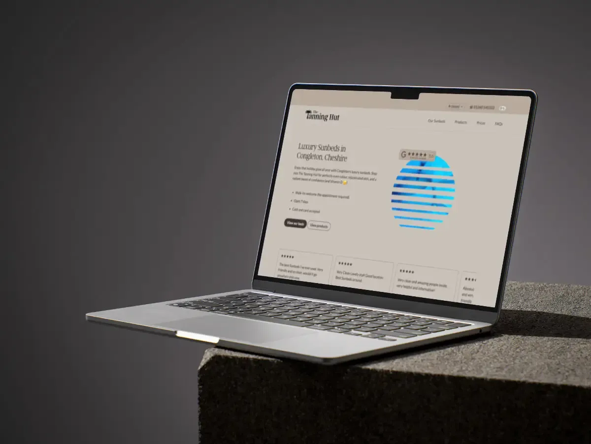 Macbook laptop with sunbed shop website displayed on the screen